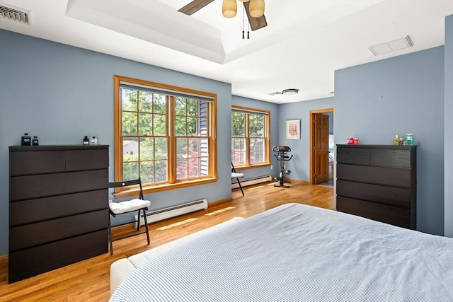 294 Cardinal Way, Northampton, MA 01062 - bedroom featuring a baseboard radiator, a baseboard heating unit, wood finished floors, and a tray ceiling