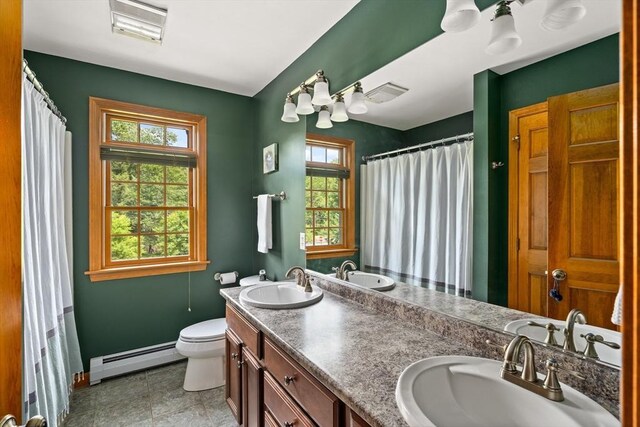294 Cardinal Way, Northampton, MA 01062 - full bath with baseboard heating, double vanity, plenty of natural light, and a shower with shower curtain