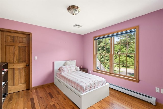 294 Cardinal Way, Northampton, MA 01062 - bedroom with a baseboard heating unit and wood finished floors