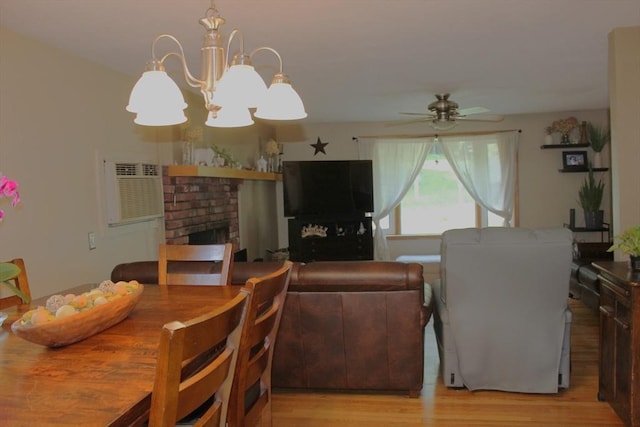 276 Newport Ave, Attleboro, MA 02703 - dining room with a chandelier, ceiling fan, light wood-type flooring, and a fireplace