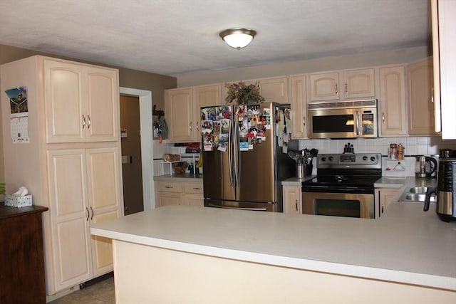 276 Newport Ave, Attleboro, MA 02703 - kitchen featuring stainless steel appliances, a peninsula, light countertops, and light brown cabinetry