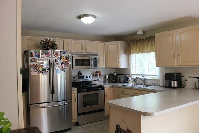 276 Newport Ave, Attleboro, MA 02703 - kitchen with stainless steel appliances, a peninsula, light brown cabinetry, light countertops, and backsplash