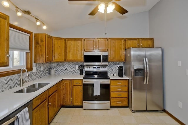 kitchen with a sink, light countertops, brown cabinets, and stainless steel appliances