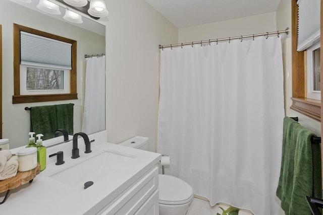 bathroom with a shower with shower curtain, toilet, and vanity