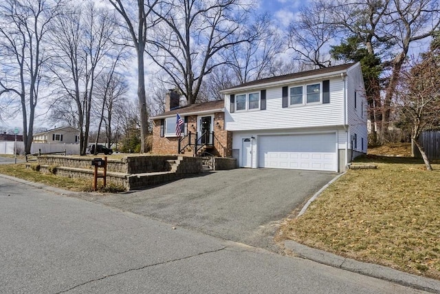 split level home with driveway, a chimney, a garage, and fence