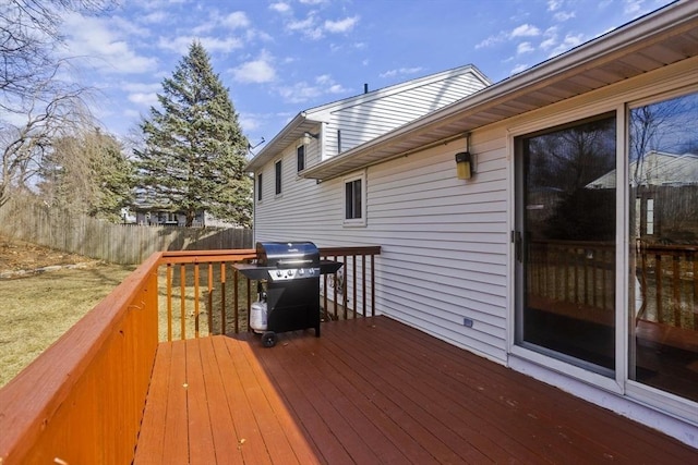 wooden deck with area for grilling and fence