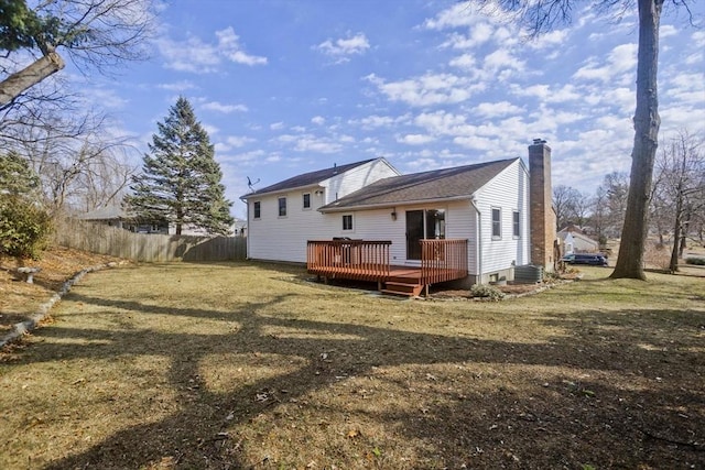 rear view of house featuring a wooden deck, cooling unit, a chimney, and fence