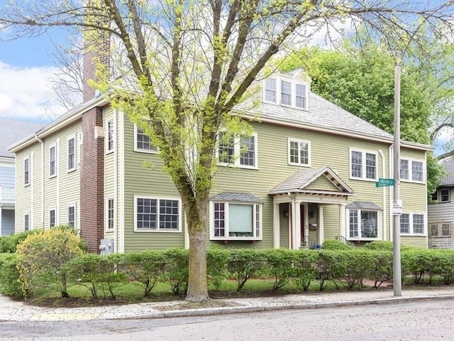 view of front of home featuring a chimney