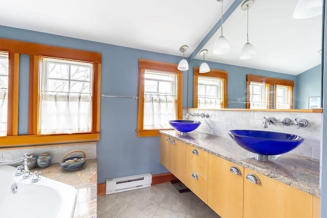 bathroom featuring backsplash, a baseboard radiator, double vanity, and marble look tile flooring