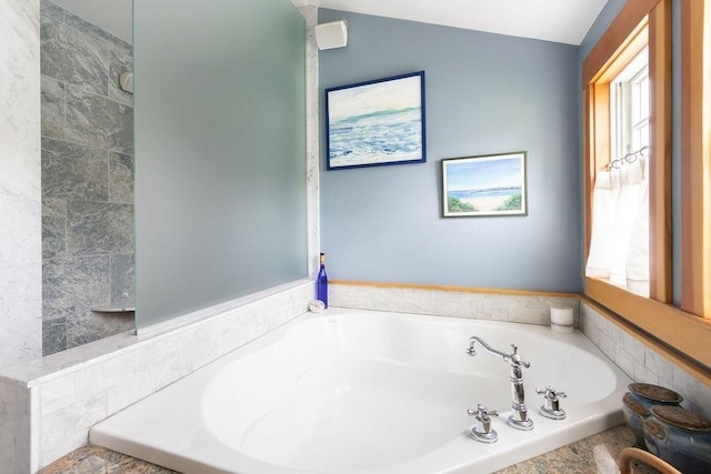 full bath with a bath and plenty of natural light