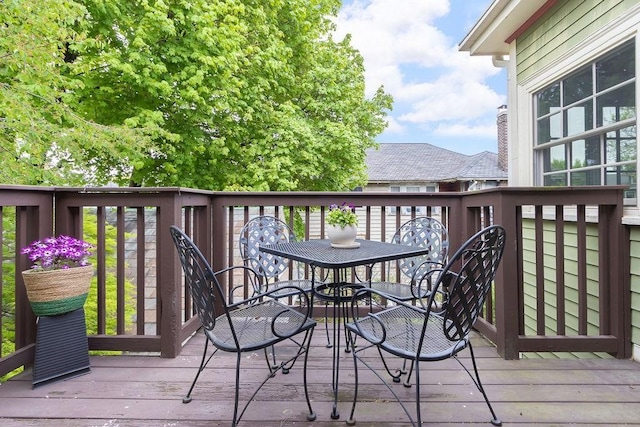 wooden deck featuring outdoor dining area
