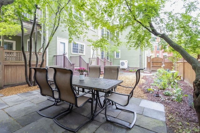 view of patio / terrace with a gate, outdoor dining area, and fence