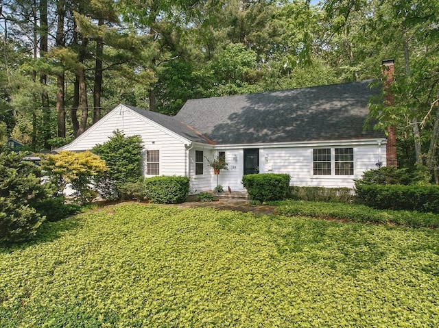 128 Lovell Rd, Holden, MA 01520 - view of front of property with a chimney, a front yard, and roof with shingles