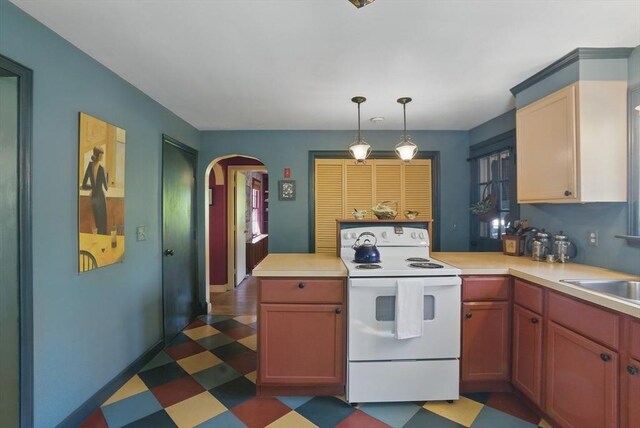 128 Lovell Rd, Holden, MA 01520 - kitchen with white electric range oven, dark flooring, a peninsula, arched walkways, and light countertops