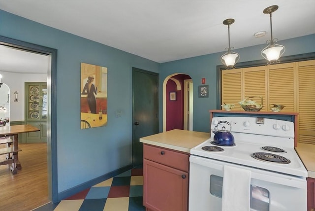 128 Lovell Rd, Holden, MA 01520 - kitchen with white electric stove, arched walkways, light flooring, light countertops, and decorative light fixtures