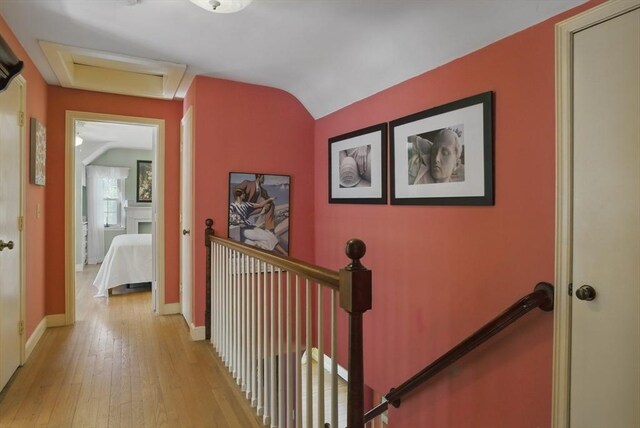 128 Lovell Rd, Holden, MA 01520 - hall with an upstairs landing, attic access, light wood-style floors, baseboards, and vaulted ceiling
