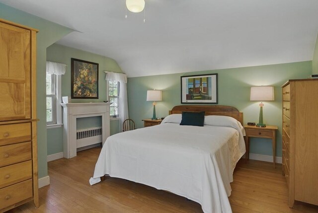 128 Lovell Rd, Holden, MA 01520 - bedroom with radiator, lofted ceiling, wood finished floors, and baseboards