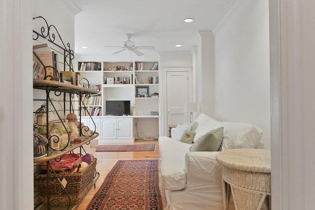 sitting room featuring a ceiling fan, ornamental molding, light wood-style floors, and recessed lighting