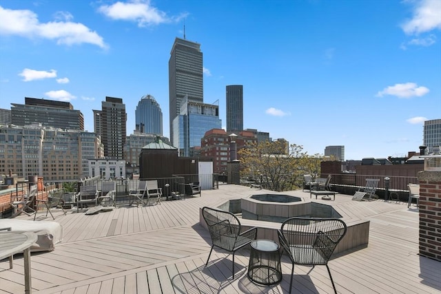 deck featuring an outdoor fire pit and a skyline view