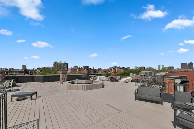 wooden deck with central AC and a view of city