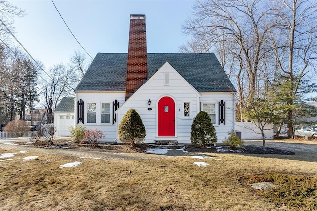 tudor house with a front yard and a garage