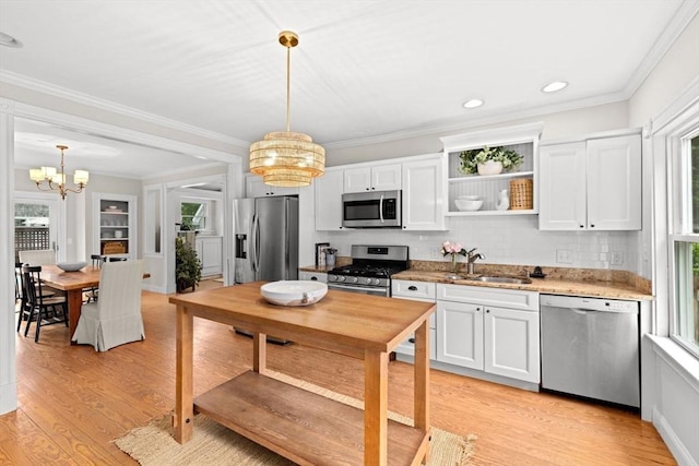 12 Short St, Cohasset, MA 02025 - kitchen with appliances with stainless steel finishes, a chandelier, plenty of natural light, light wood-style floors, and crown molding