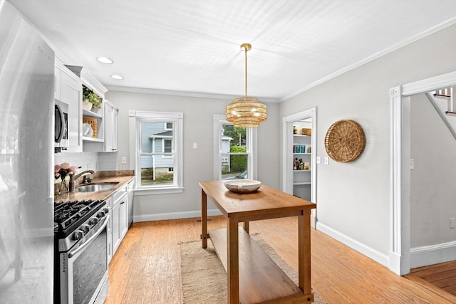 12 Short St, Cohasset, MA 02025 - kitchen with appliances with stainless steel finishes, white cabinets, open shelves, light wood-style floors, and decorative backsplash