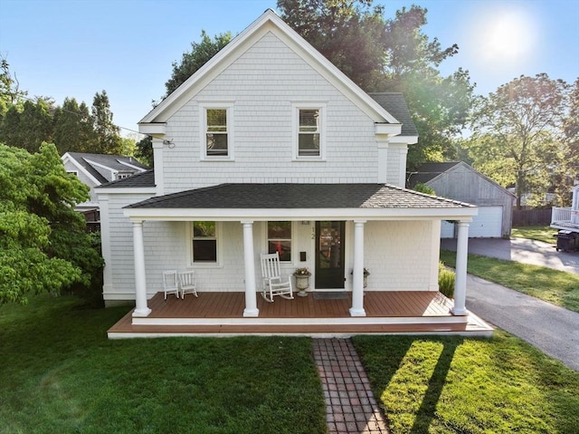 12 Short St, Cohasset, MA 02025 - view of front of house with a porch, roof with shingles, a front yard, and an outdoor structure
