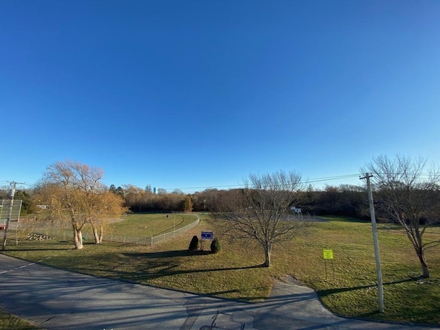 view of front facade featuring a rural view and a front yard