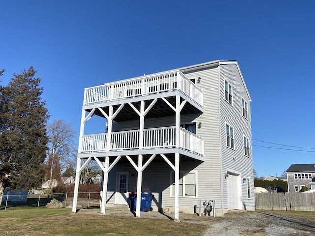 back of property with a deck and a garage