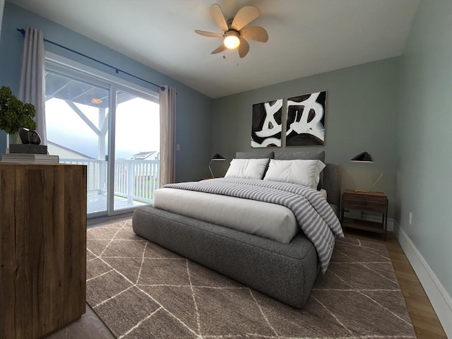 bedroom featuring access to exterior, dark hardwood / wood-style flooring, and ceiling fan