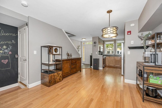129 Merrimac Unit 19, Newburyport, MA 01950 - foyer entrance featuring light wood finished floors and baseboards