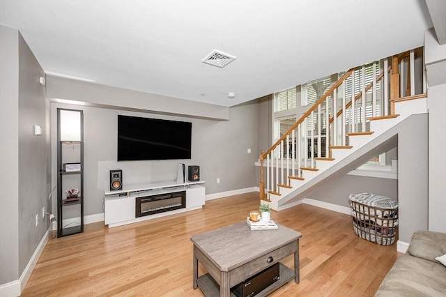 129 Merrimac Unit 19, Newburyport, MA 01950 - living area with light wood finished floors and stairway