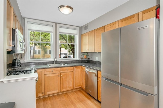 129 Merrimac Unit 19, Newburyport, MA 01950 - kitchen featuring stainless steel appliances, light wood-style floors, and dark countertops