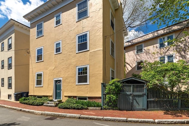 view of apartment building / complex with fence