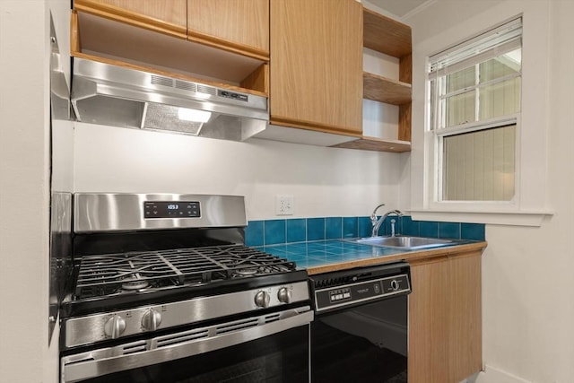 kitchen with stainless steel range with gas stovetop, black dishwasher, a sink, under cabinet range hood, and open shelves