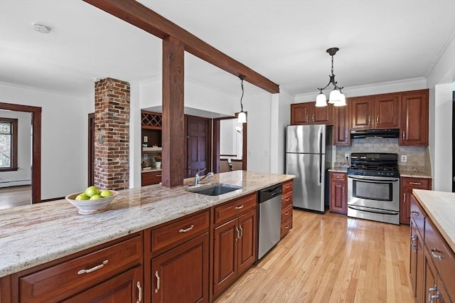 kitchen featuring range hood, a sink, light wood finished floors, appliances with stainless steel finishes, and backsplash