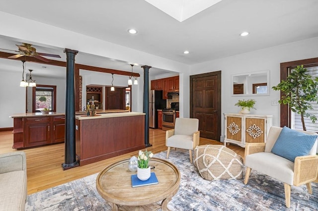 living room with ornate columns, recessed lighting, light wood-style flooring, and a ceiling fan
