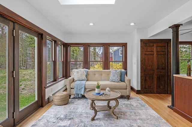 sunroom featuring recessed lighting, decorative columns, and wood finished floors