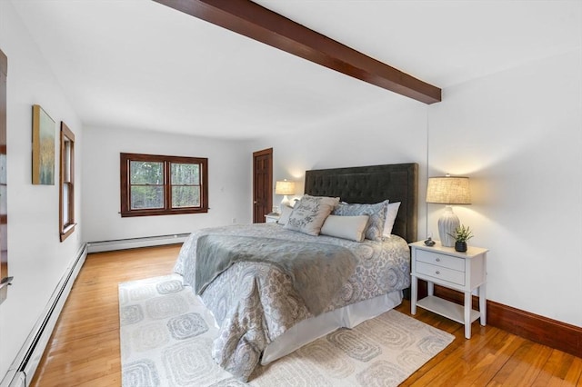 bedroom featuring baseboards, a baseboard radiator, light wood-style flooring, and beam ceiling