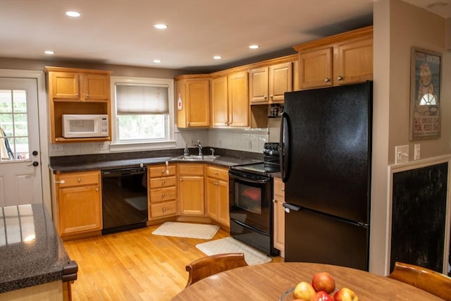 15 Lambert Ave, Stoughton, MA 02072 - kitchen with black appliances, plenty of natural light, light wood finished floors, and recessed lighting
