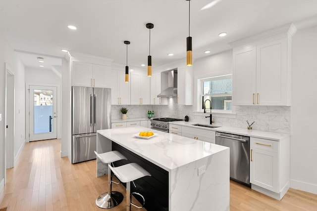 kitchen featuring white cabinetry, high end appliances, a kitchen island, and sink