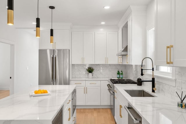 kitchen featuring white cabinets, light stone countertops, hanging light fixtures, and high quality appliances