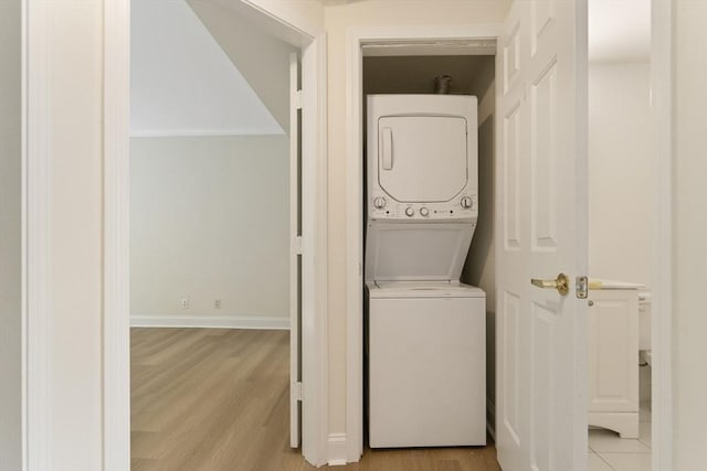 188 Newton Unit 6, Boston, MA 02135 - laundry room with stacked washer / dryer, light wood finished floors, and baseboards