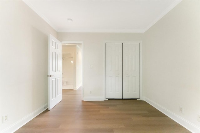 188 Newton Unit 6, Boston, MA 02135 - unfurnished bedroom featuring crown molding, wood finished floors, baseboards, and a closet