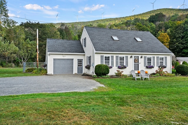 new england style home with a front yard and a garage