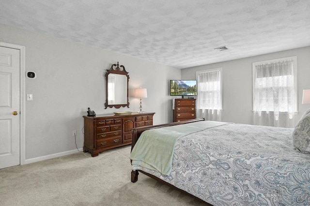 155 Burlington St, Woburn, MA 01801 - bedroom featuring a textured ceiling, light colored carpet, and baseboards