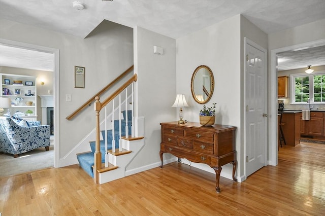 155 Burlington St, Woburn, MA 01801 - stairway with wood finished floors, baseboards, and a fireplace