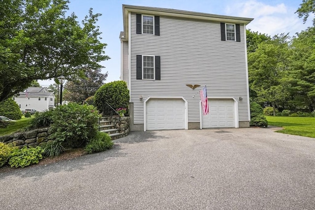 155 Burlington St, Woburn, MA 01801 - view of home's exterior featuring asphalt driveway, an attached garage, and stairs