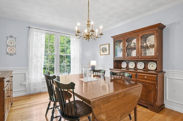 155 Burlington St, Woburn, MA 01801 - dining space with a chandelier, a decorative wall, wainscoting, light wood finished floors, and ornamental molding